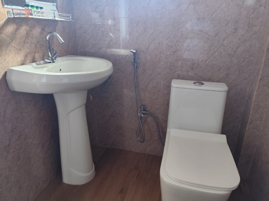 Attached Bathroom with Ceramic Basin and Commode
