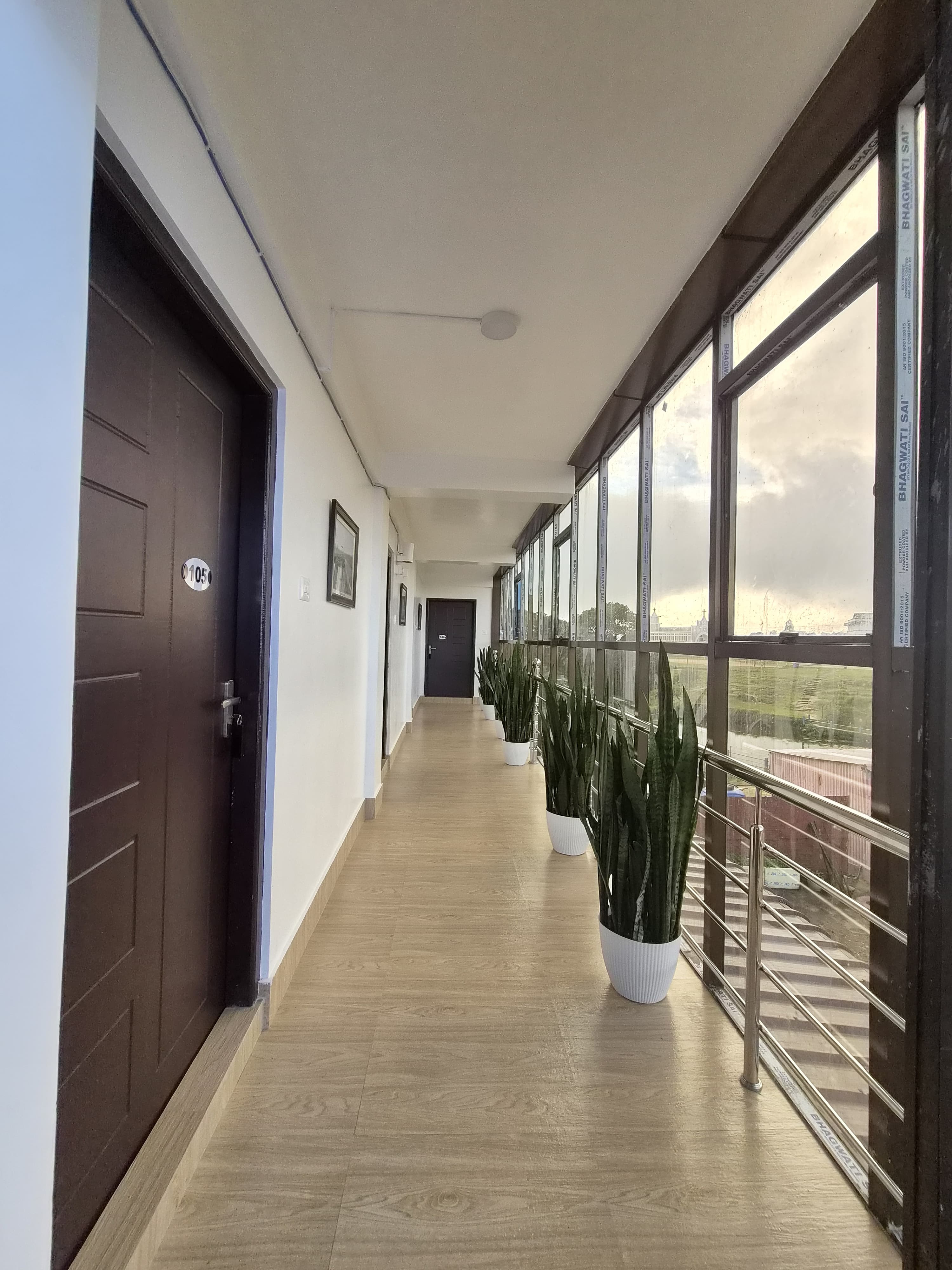 Glass corridor with potted plants